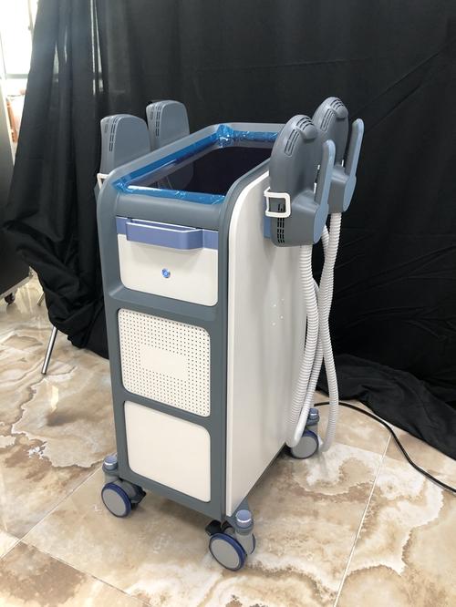 Professional using EMS NEO body sculpting machine in clinic
