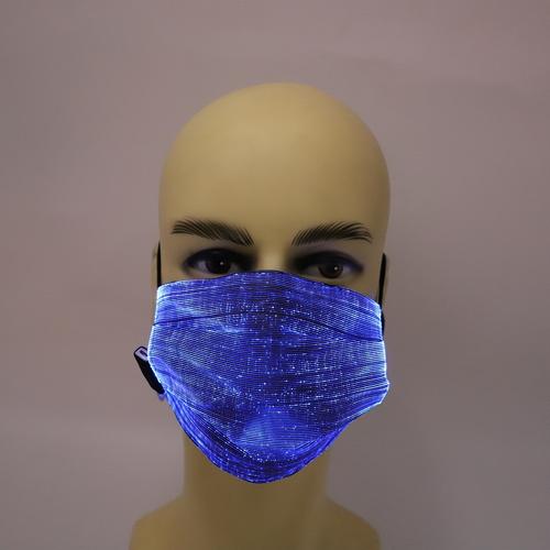 Woman using rechargeable LED face mask at home