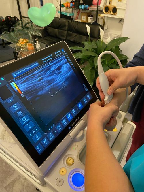Medical professional using ultrasound scanner in clinic