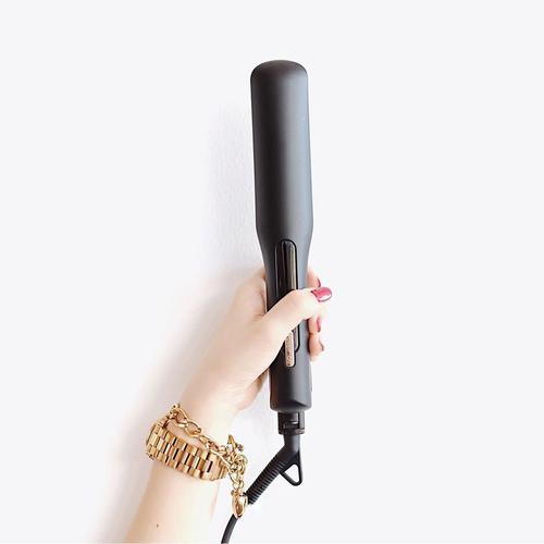Professional using mini hair crimper for textured hairstyle